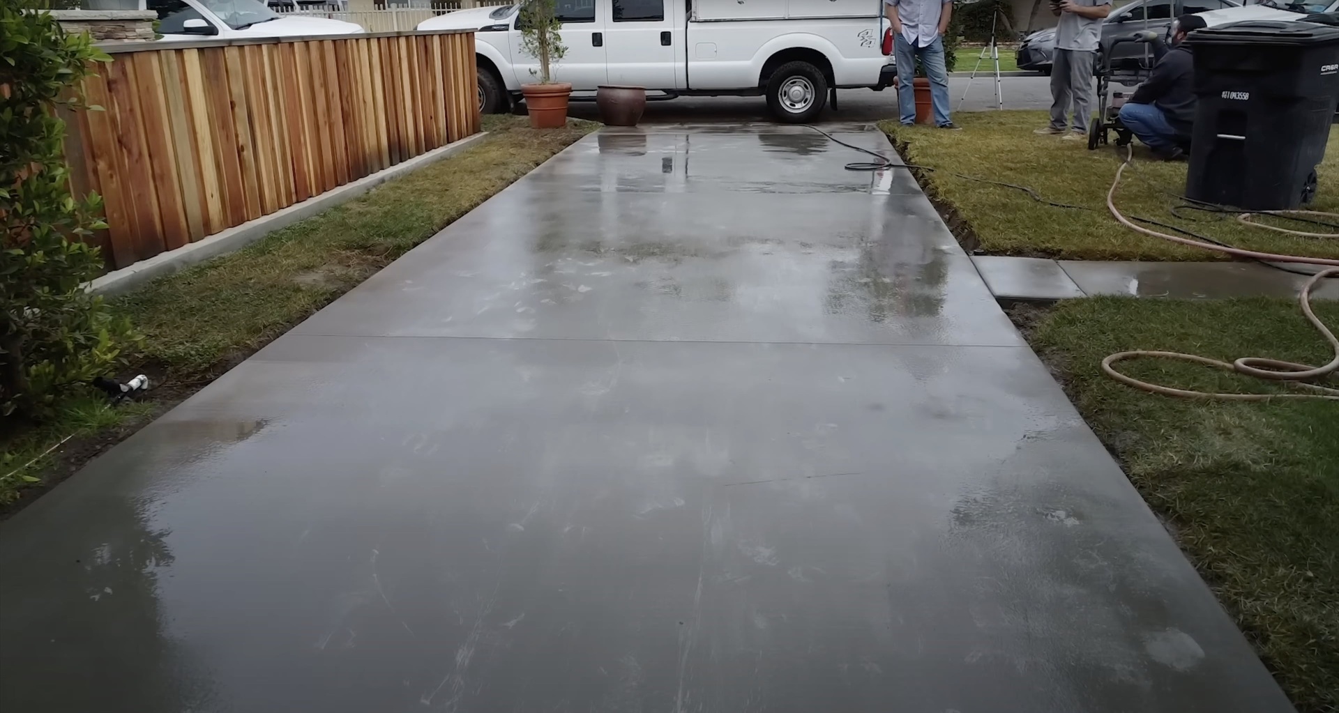New concrete driveway being professionally installed Fresh concrete driveway installation by professional contractors