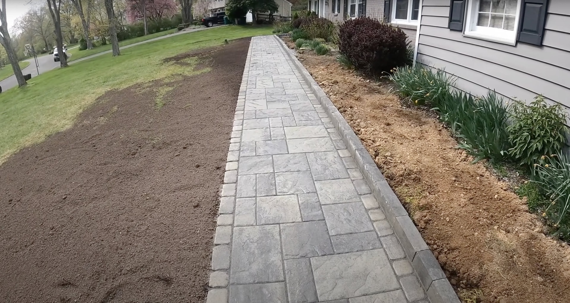 Beautiful stamped concrete walkway with decorative stone pattern Stamped concrete walkway with decorative pattern and professional landscaping
